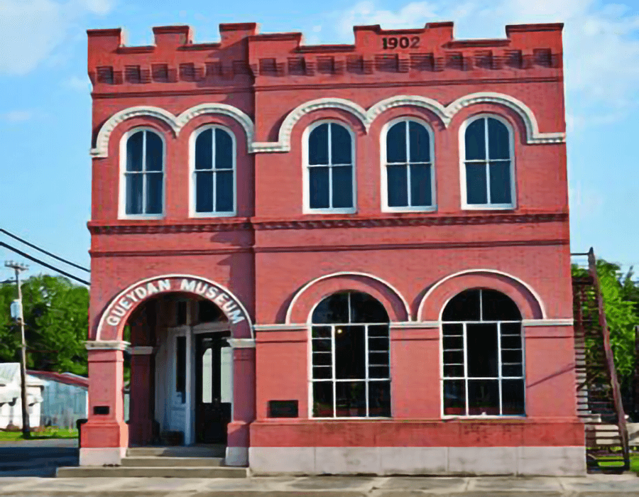 Historic red brick building labeled "Cuedan Museum," established in 1902.
