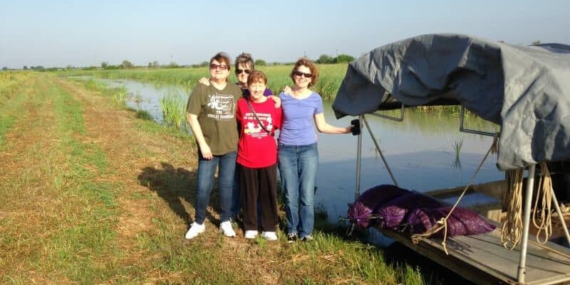 4 ladies standing next to crawfish boat
